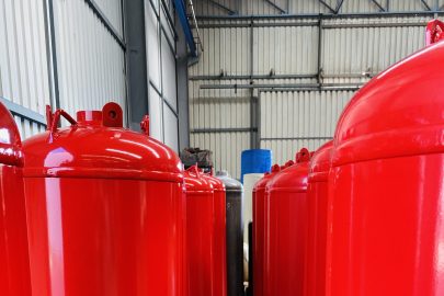 Production line of red TPED-certified clean agent fire suppression cylinders ready for shipment