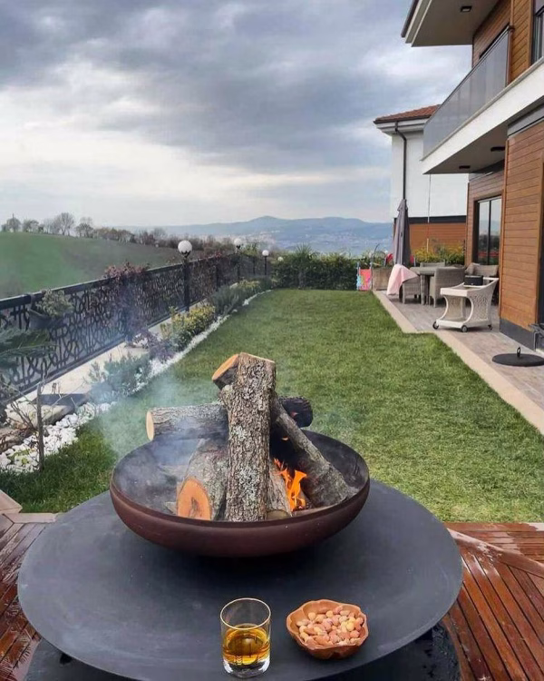 Fumolio Fuji Fire Pit with wood storage in outdoor area
