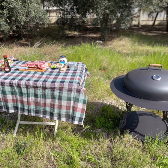 Real-life Fumolio Mauna fire pit with grill accessory in a luxury restaurant gardenReal-life Fumolio Mauna fire pit with grill accessory in a luxury restaurant garden