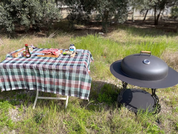 Real-life Fumolio Mauna fire pit with grill accessory in a luxury restaurant gardenReal-life Fumolio Mauna fire pit with grill accessory in a luxury restaurant garden